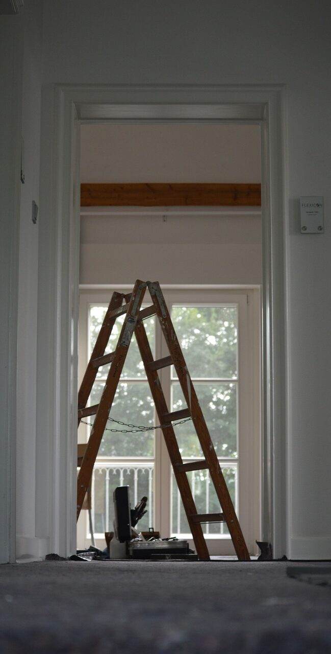 A ladder leaning up against the wall of a room.
